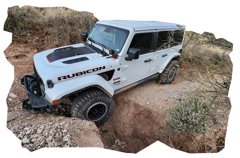 White Rubicon Jeep Stuck in Ditch