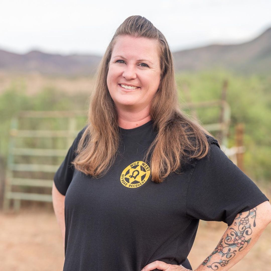 Employee Posing in Front of Wild West Off-Road Recovery Tow Truck